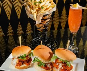 sliders , fries and a French 75 drink
